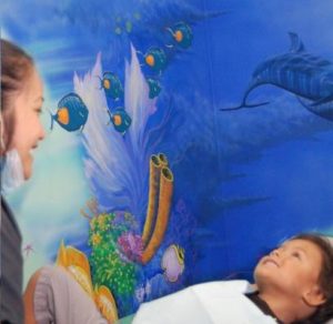 young patient enjoys ocean-themed mural