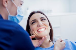 woman smiling up at dentist in a dental chair