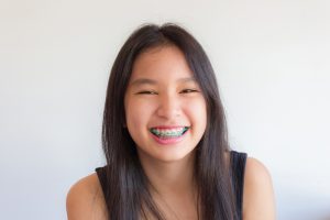 smiling young girl wearing braces